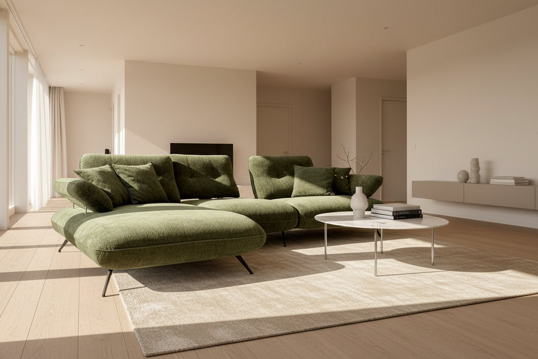 Canapé d'angle méridienne vert avec dossiers avance recule exposé au magasin de meubles - confort luxe
